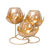 Modern piece of art with metal leaves in gold finish with three amber glass candle holders